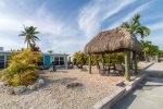 Spacious backyard with outdoor grill, tiki hut and seating